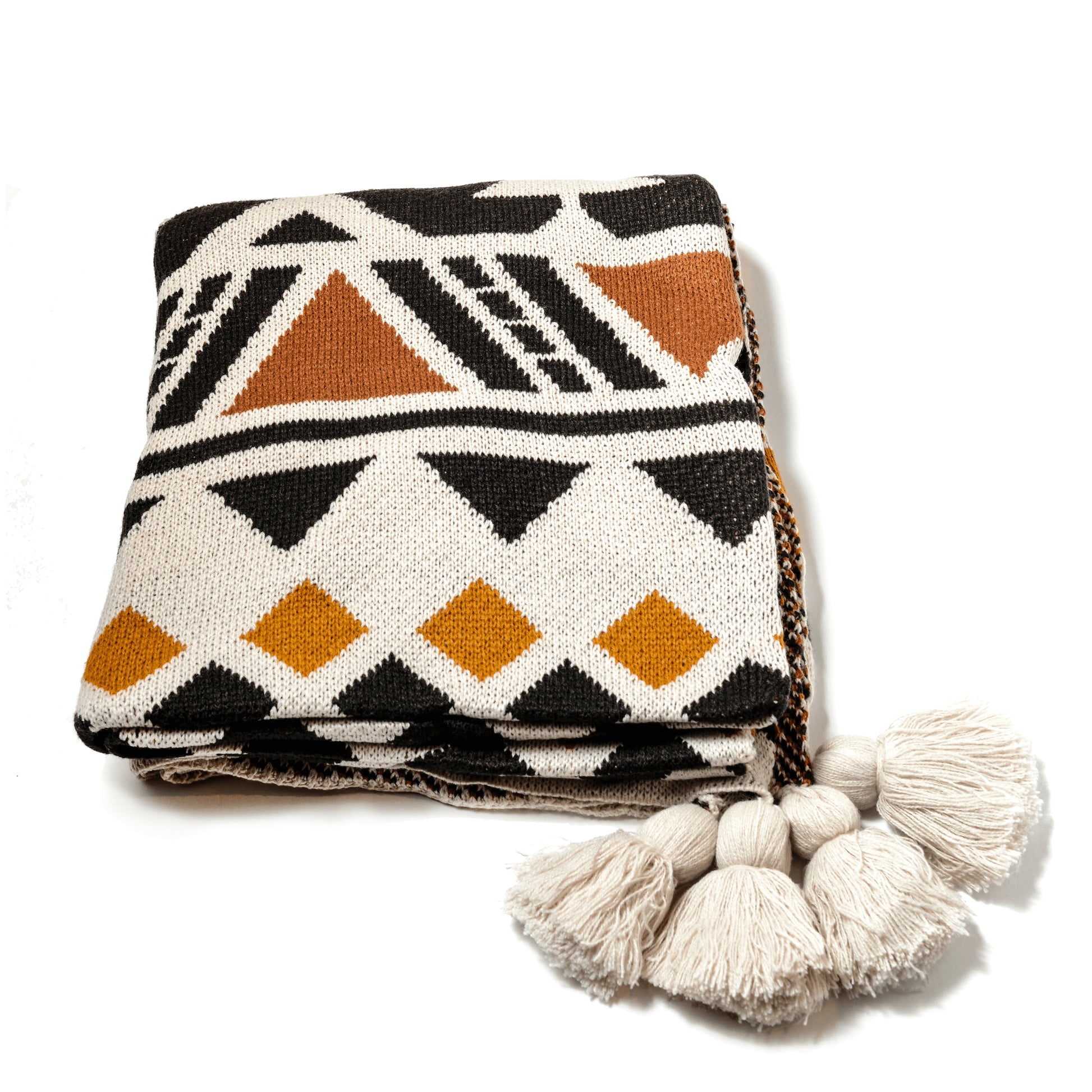 Plaid Bohème à motif posé et plié sur un fond blanc