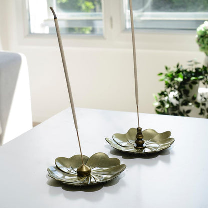 Porte encens bohème en forme de lotus posé sur une table dans un salon à l’ambiance cocooning